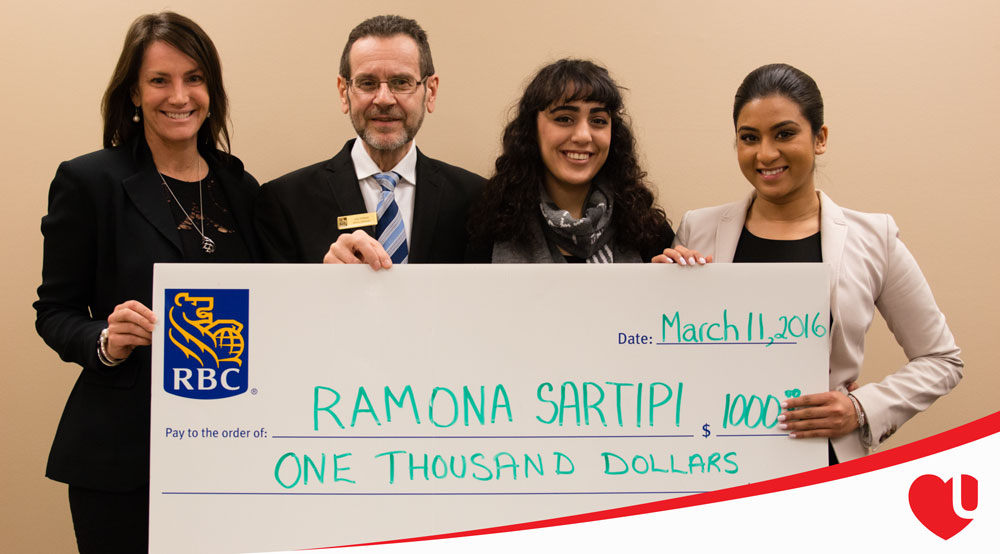 Ramona being presented with a giant check by the RBC staff.